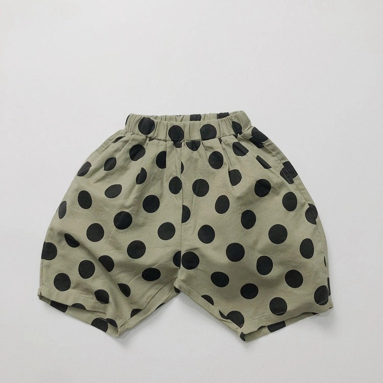 Dotter Linen Blend Pants in Green Polka Dot, flat lay on white background showing sage green 55% linen 45% cotton with bold allover black polka dot print, high elasticated waistband with gathered fullness, side pockets, and voluminous ballooned cropped leg
