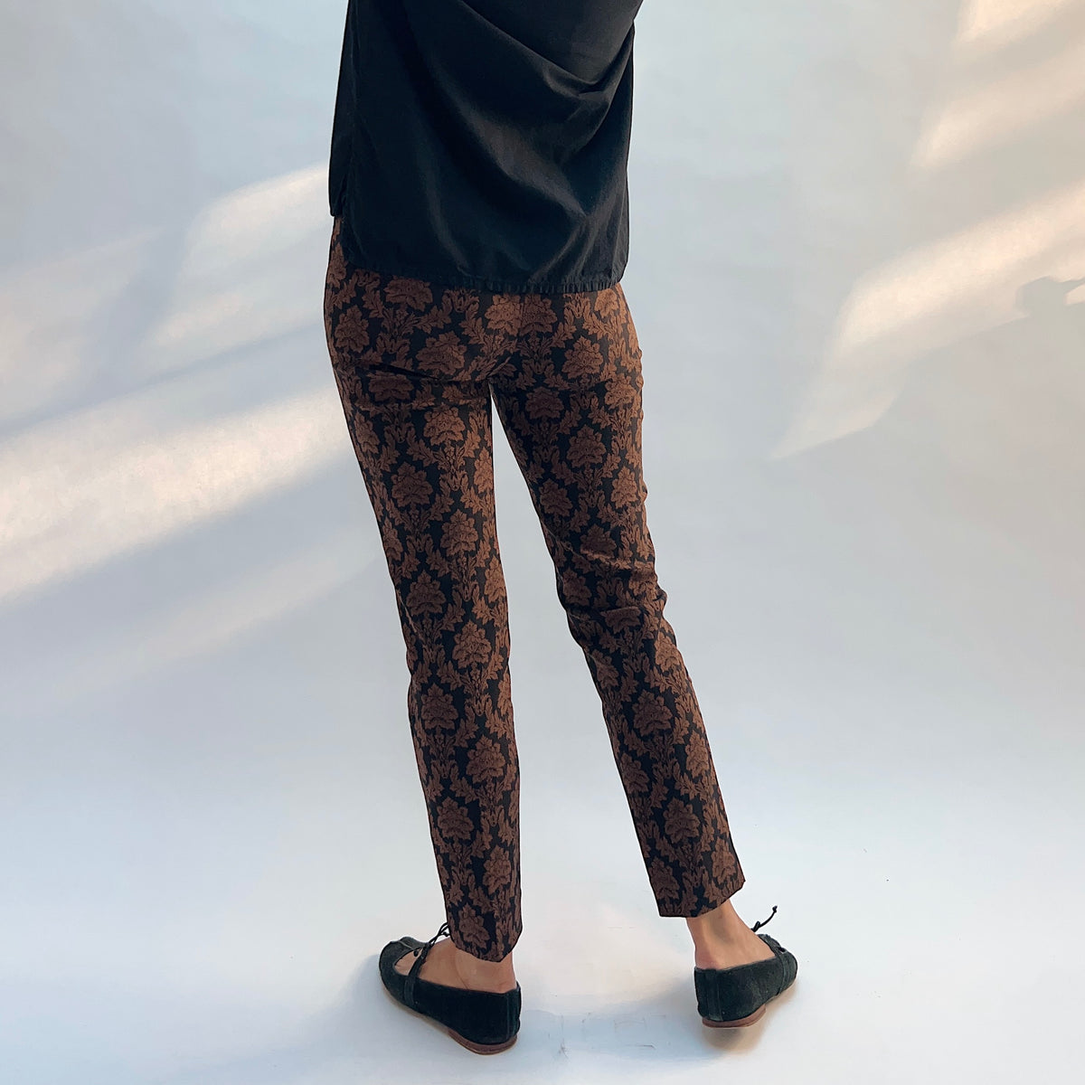 Lisette Chocolate Brocade Cigarette Pant, back view showing the elastic waistband and slim ankle fit in chocolate damask jacquard