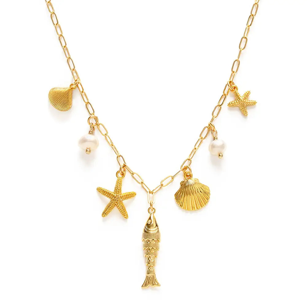 Gold necklace with starfish, shell, and fish charms on a white background
