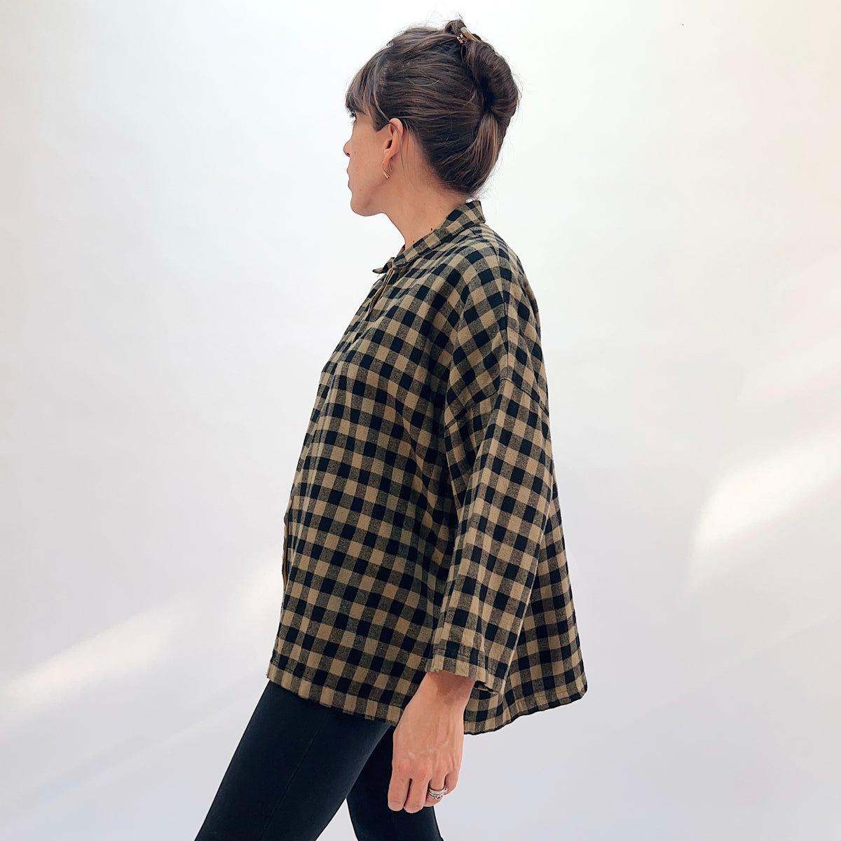 Eleven Stitch Big Check Big Shirt in Olive, side profile view showing the boxy hip-length fit and 3/4-length sleeves in olive and black gingham check flannel