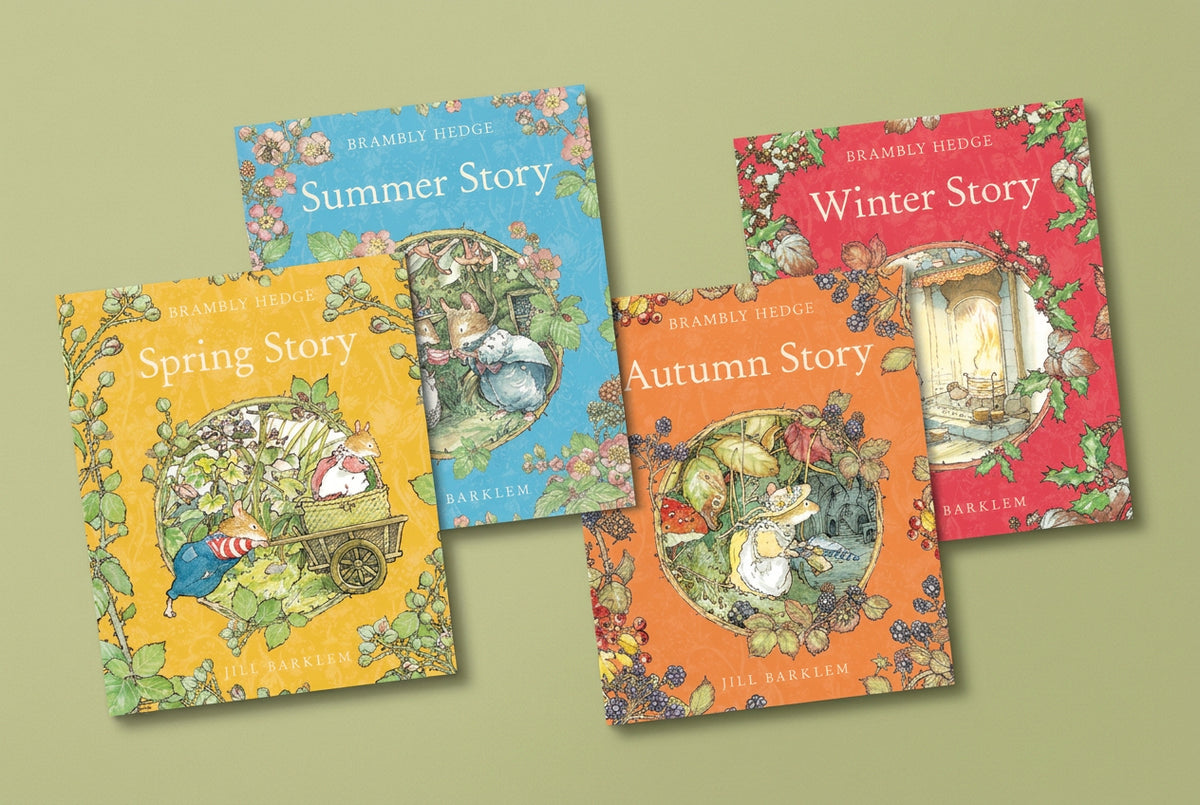 The four Brambly Hedge seasonal books displayed together, with yellow Spring Story, blue Summer Story, orange Autumn Story, and red Winter Story covers.