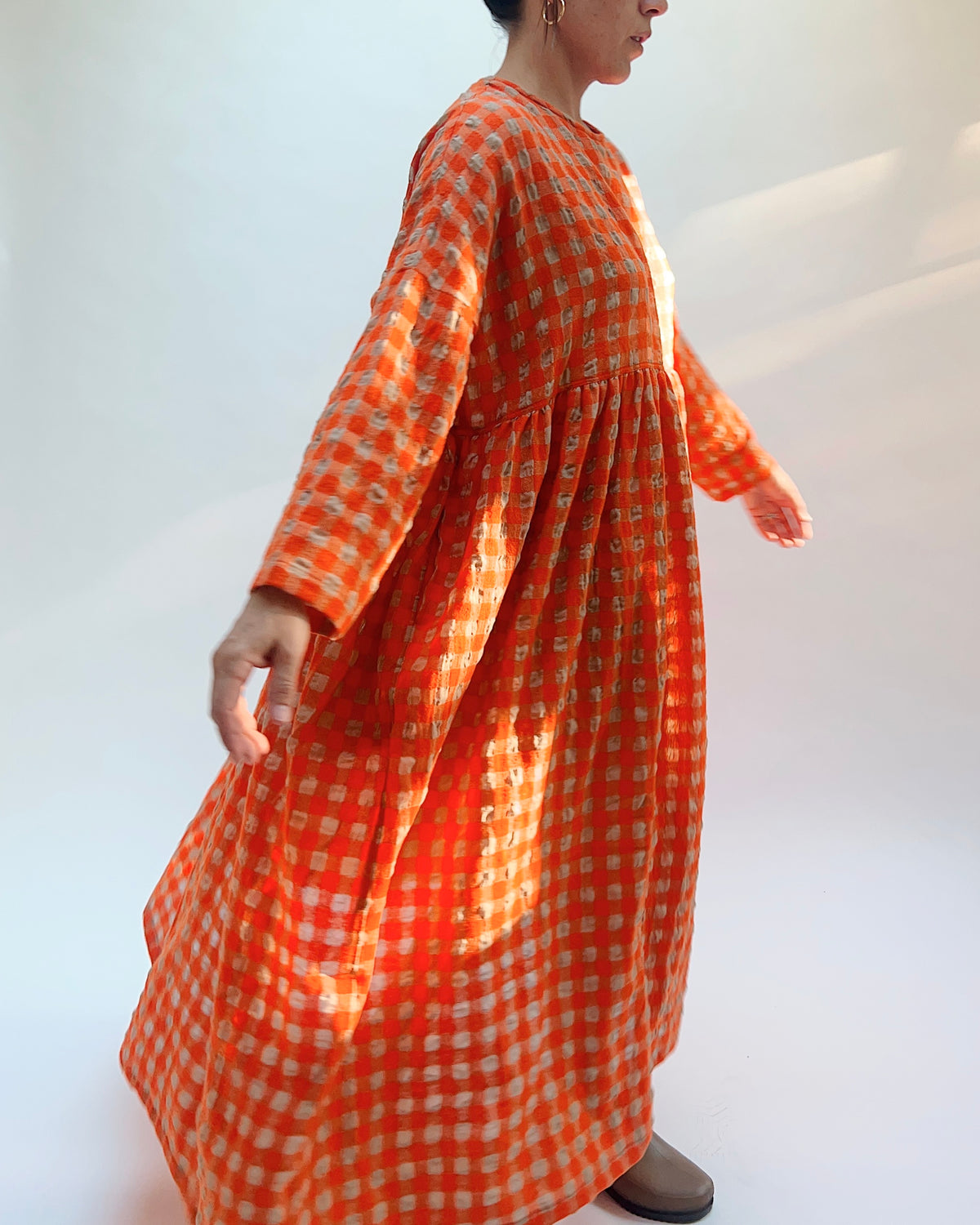 Ichi Antiquités Gingham Wool Check Dress in Beige & Orange, side view showing the full sweeping skirt in motion