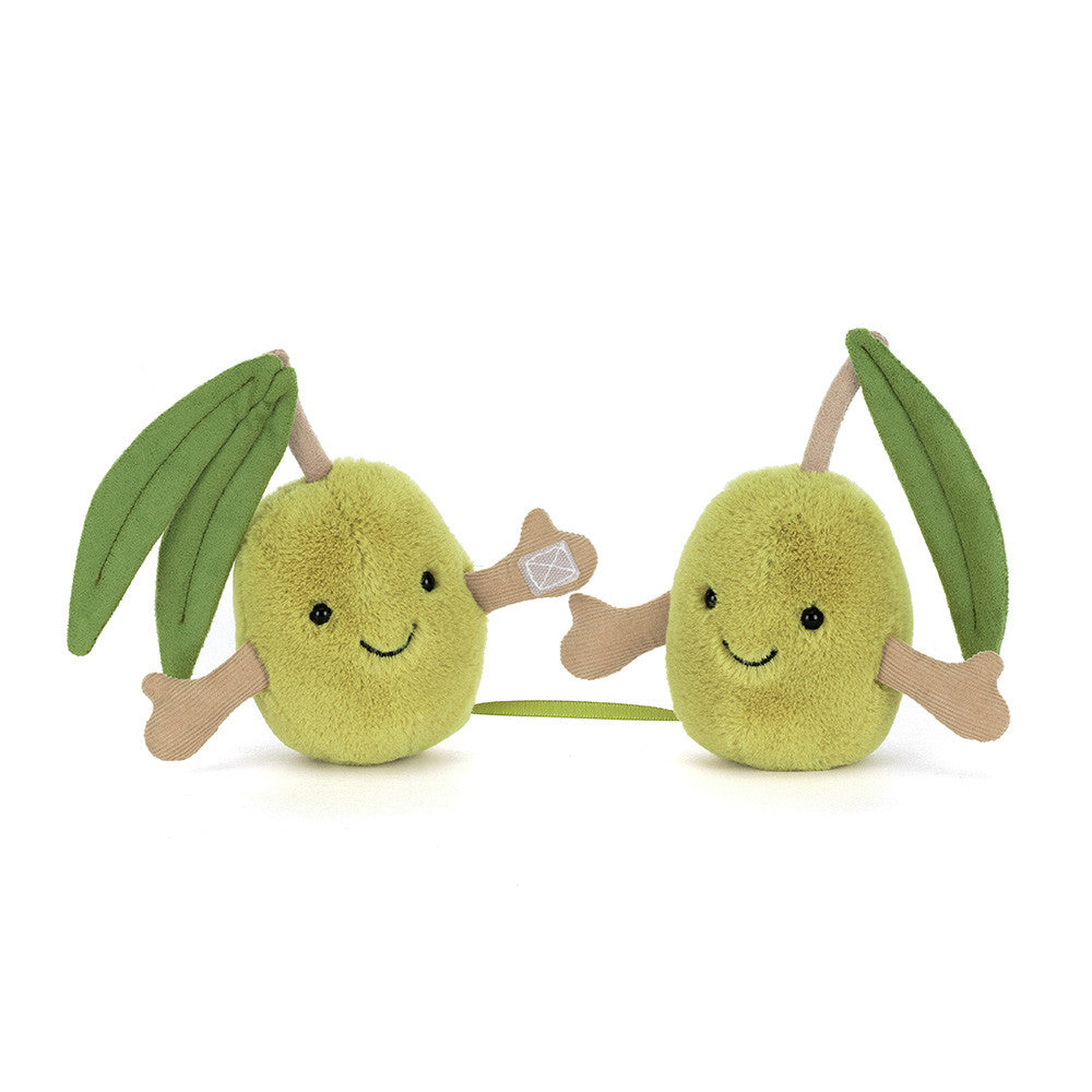 Two plush olive toys with leafy stems on a white background