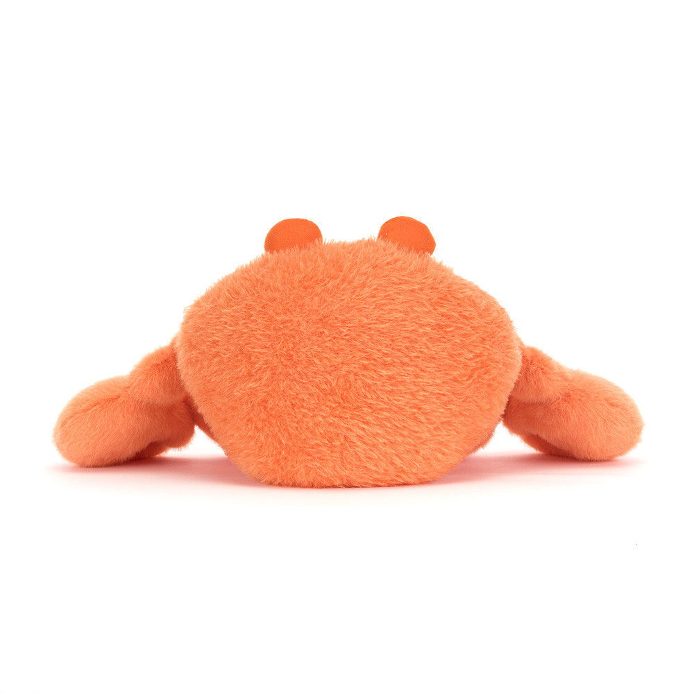 Orange plush crab toy on a white background as seen from behind