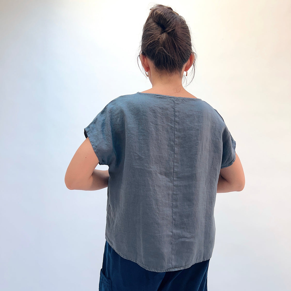 Dotter & Sons High Low Linen Tee in Pewter, back view showing the longer hi-lo hem and center back seam detail in pewter linen