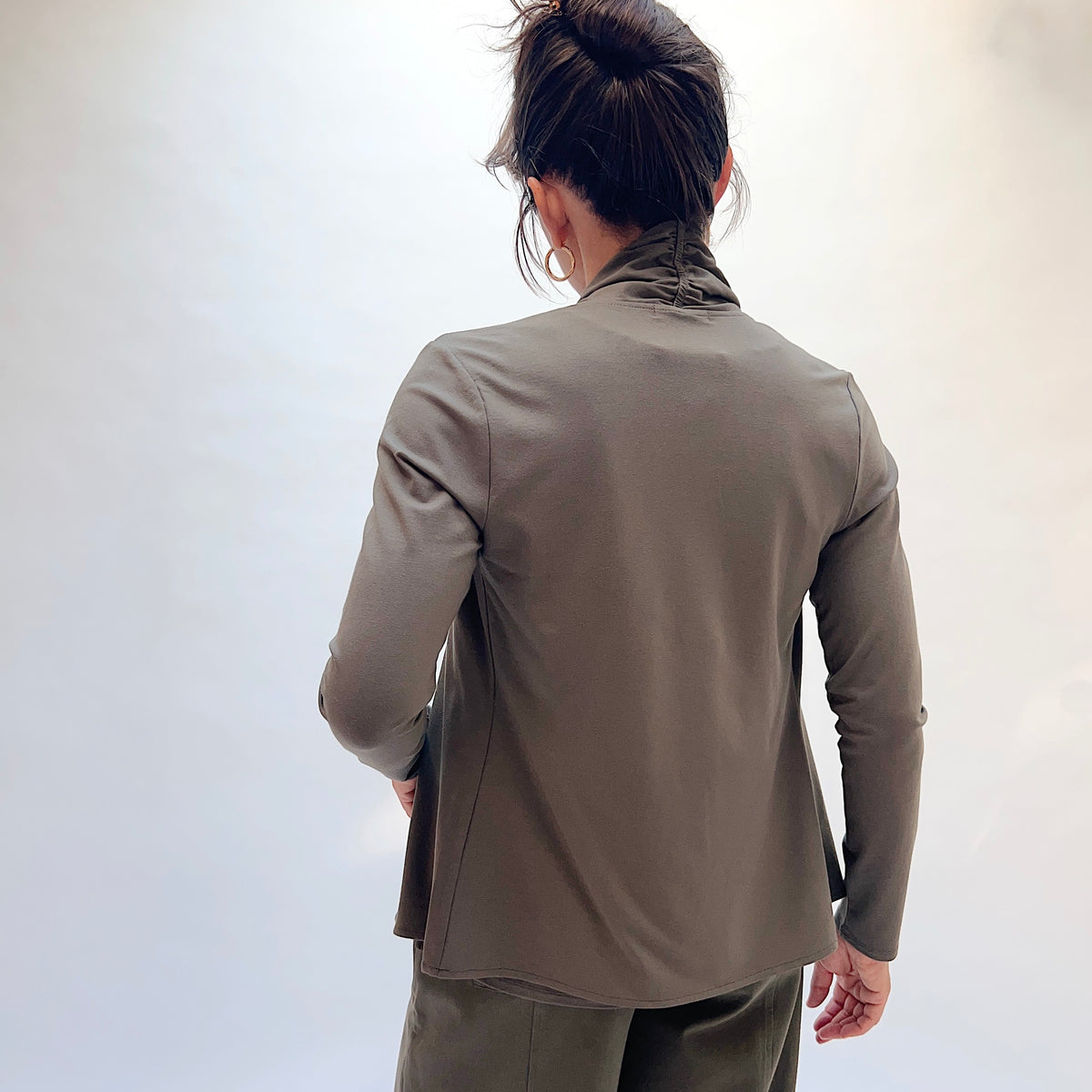 Habitat Core Travel Waterfall Jacket in Umber, back view showing the fitted silhouette and back seam detail