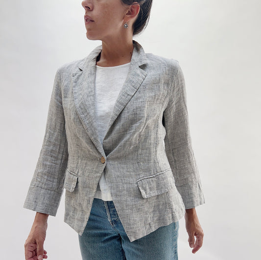Front view of the Linen Blazer in Grey Pinstripe by Yuvita, showing the notched lapel, single-button closure, and relaxed fit, styled with a white linen tee and blue jeans