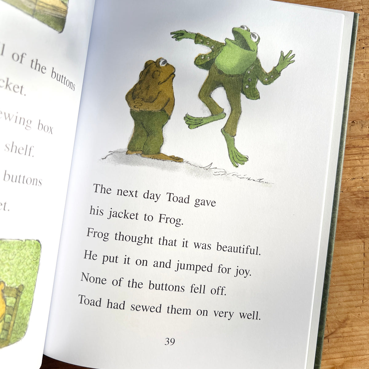Open page of Frog and Toad Are Friends showing Frog jumping for joy in a button-covered jacket while Toad watches.