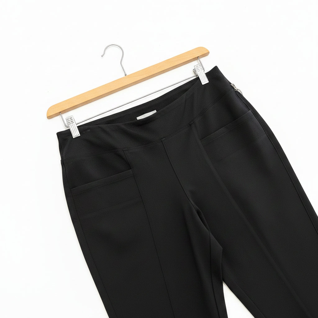 Black pants on a hanger against a white background