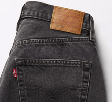 Load image into Gallery viewer, Close-up of a Levi's jeans back pocket with brand label on a white background