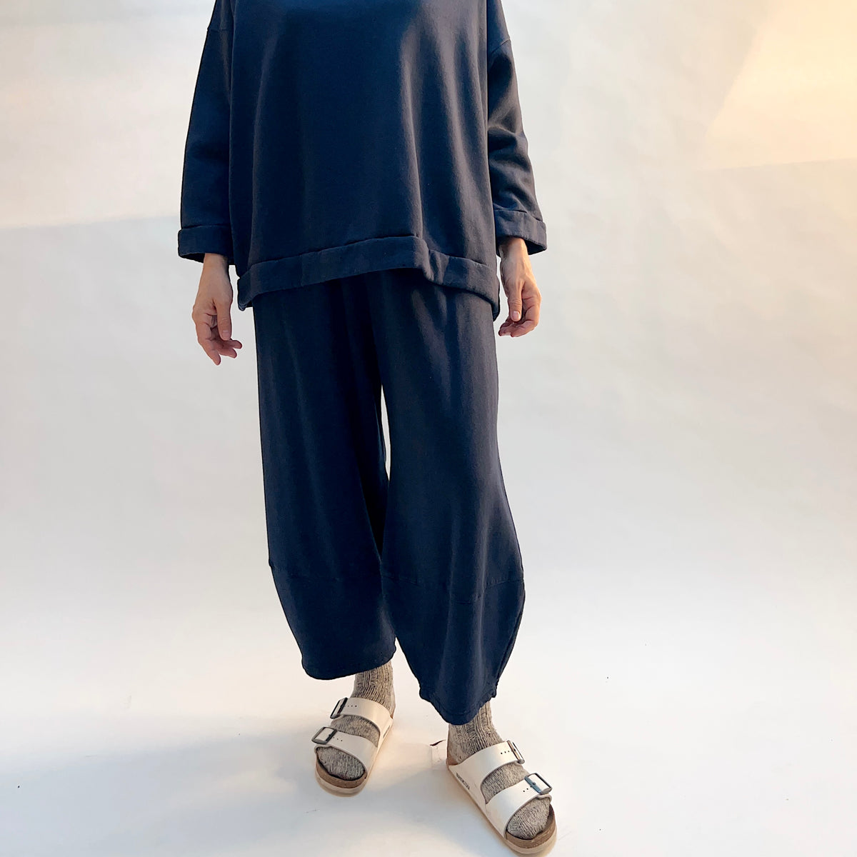 Front view of Oliver Fleece Pant in Nova on a model, showing the loose leg shape and horizontal lower-leg seams.
