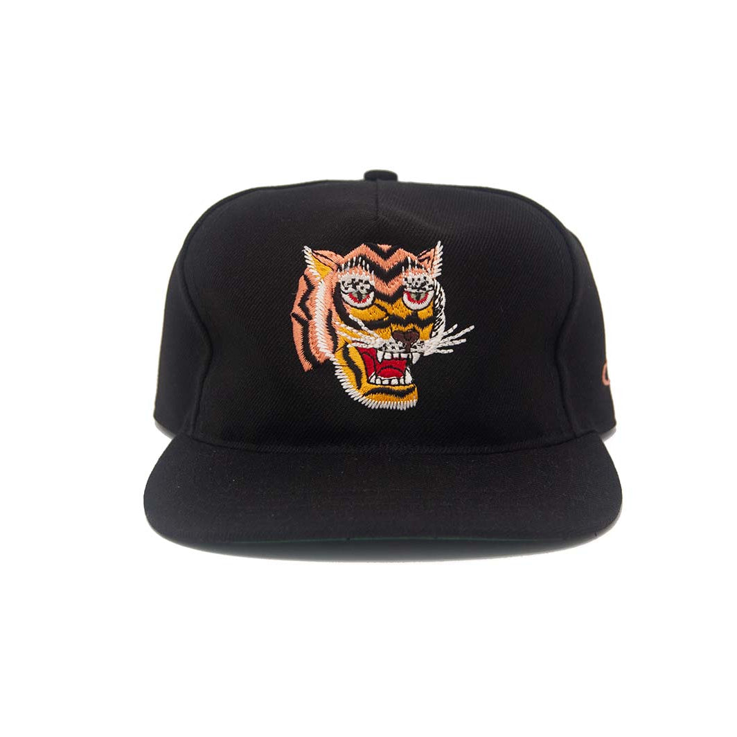 Front view of the Ampal Creative Tiger III Black Snapback, featuring a large embroidered roaring tiger head in orange, gold, red, and white inspired by Vietnam-era souvenir jacket patches, on a black poly upper with flat brim, on a white background
