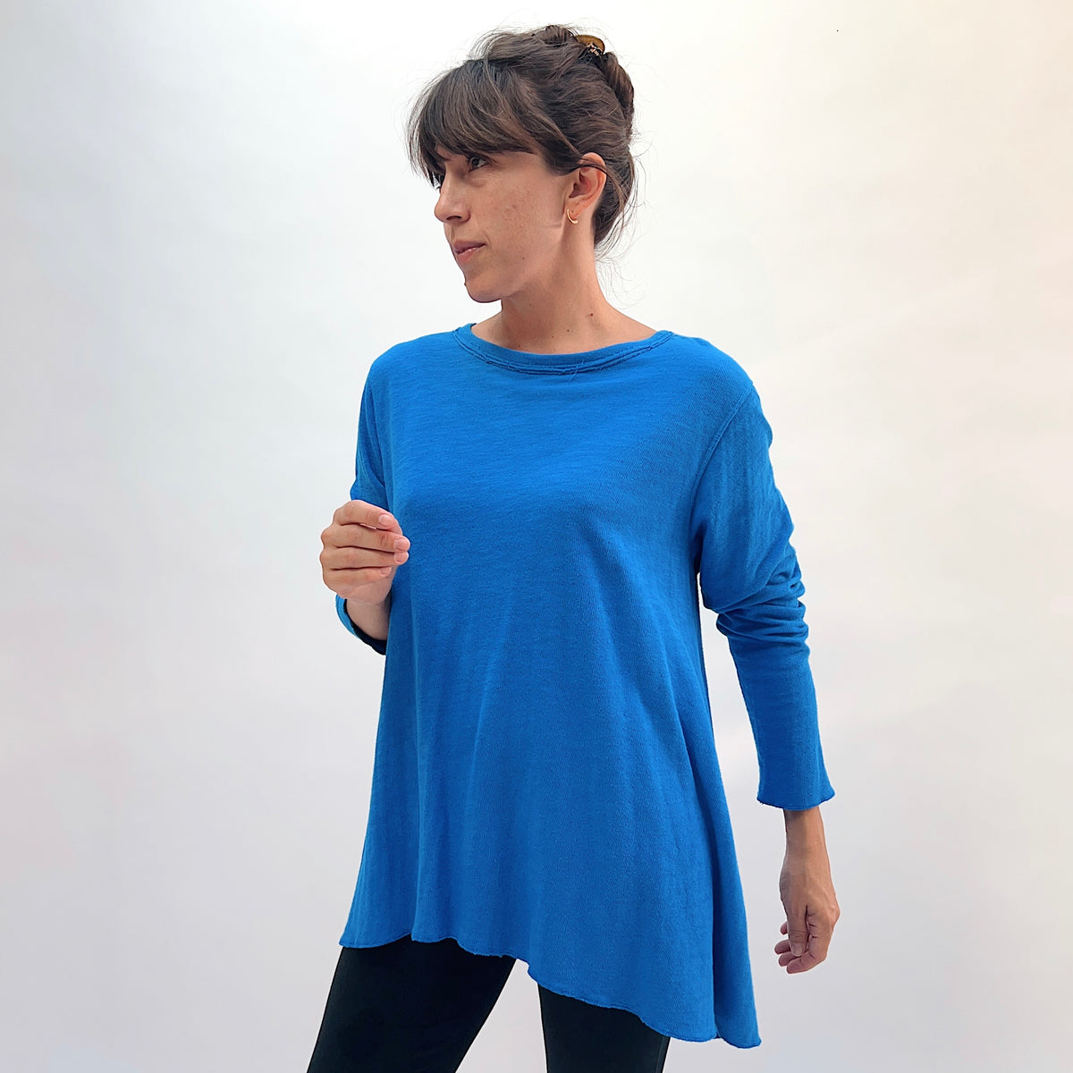 North Star Base Double Cotton Longer Angel Hem Tee in North Sea, front three-quarter view showing the A-line angel hem silhouette and raw-edge crew neck in north sea blue
