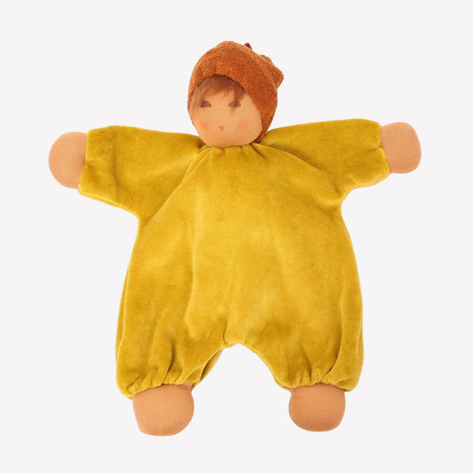 Toy baby doll wearing a mustard yellow outfit and brown hat with a light complexion on a white background