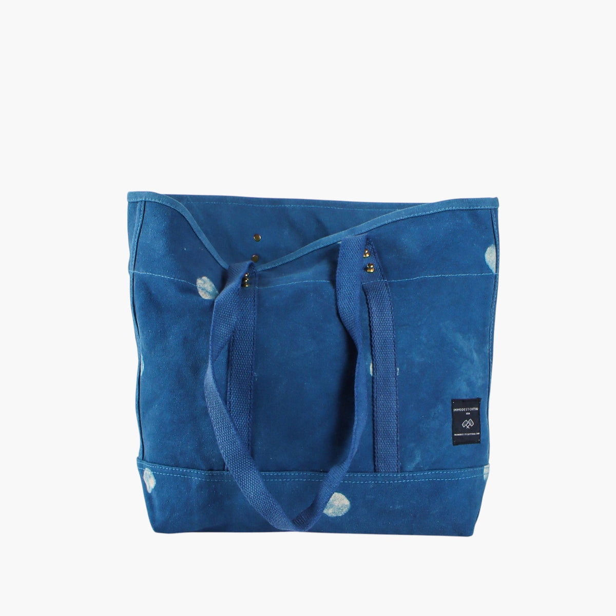 Small Light Indigo Moon tote with leather handles removed, showing the blue webbing shoulder straps.
