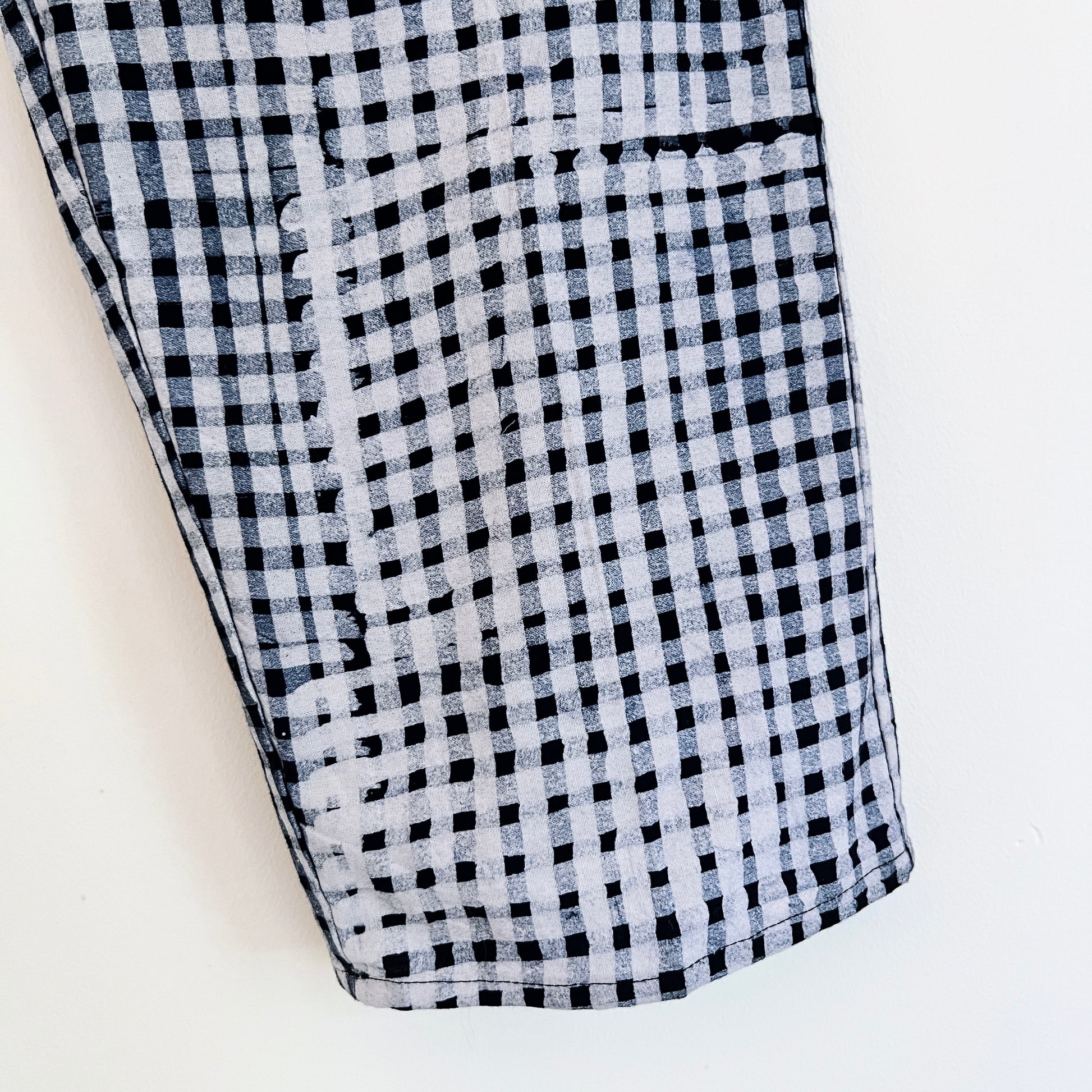 Close-up of hand-dyed indigo and white batik check fabric on Lazy Pants in Indigo Dots, showing handcrafted texture and print detail

