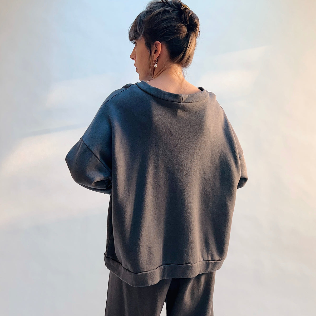 Angled back view of Alden Fleece Sweatshirt in Moonlight, showing the draped neckline and loose shape.
