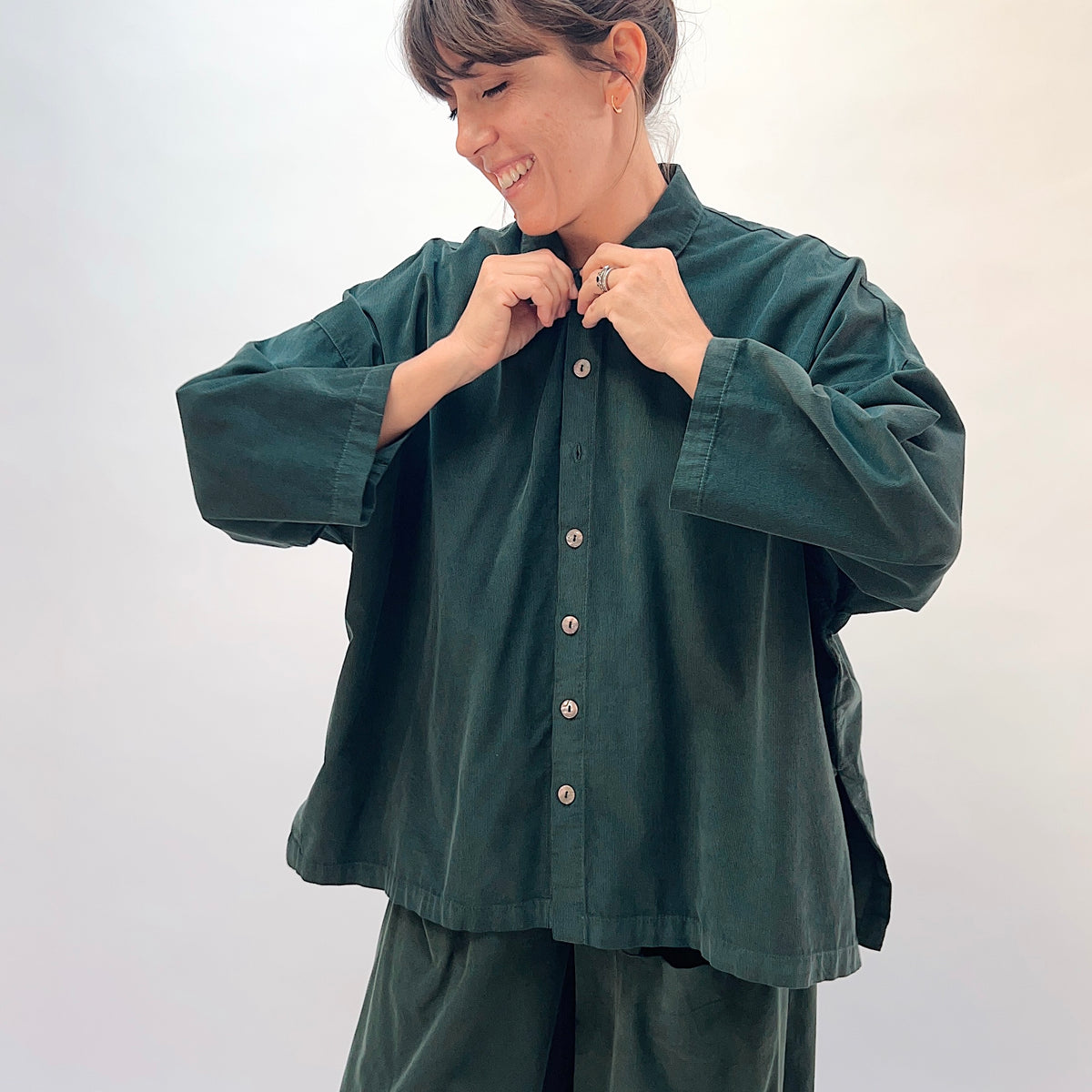 Eleven Stitch Corduroy Big Shirt in Konbu, front view showing the shell button placket and classic collar detail in dark green fine-wale corduroy
