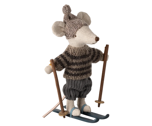 Maileg Winter Mouse Ski Big Brother — full front view of linen mouse doll wearing a taupe knit pompom hat, brown striped knit sweater, dark ribbed knickerbockers, and blue wooden skis with poles
