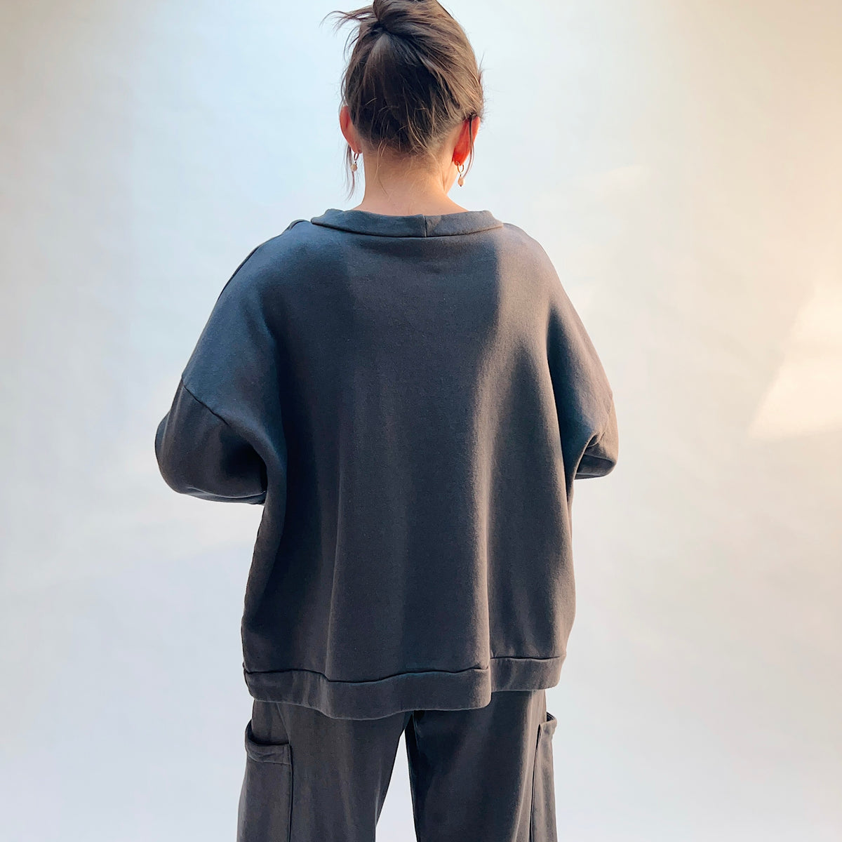 Back view of Alden Fleece Sweatshirt in Moonlight on a model, showing the wide silhouette, dropped shoulders, and banded hem.
