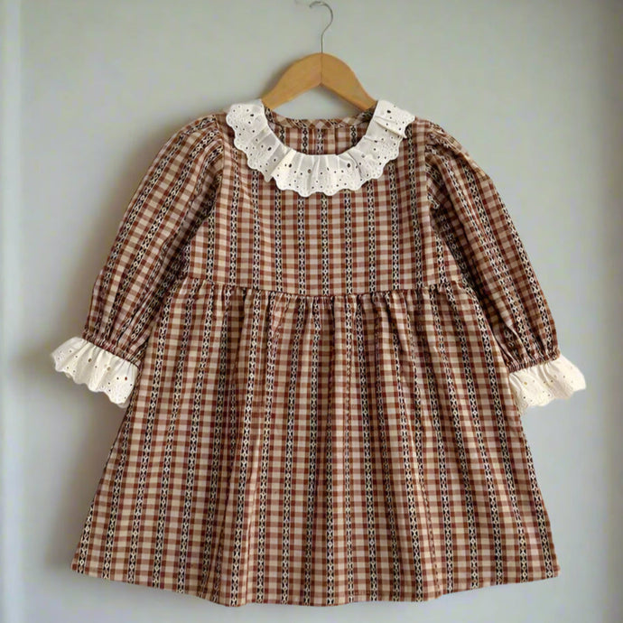 Plaid dress with lace collar and cuffs on a light gray background