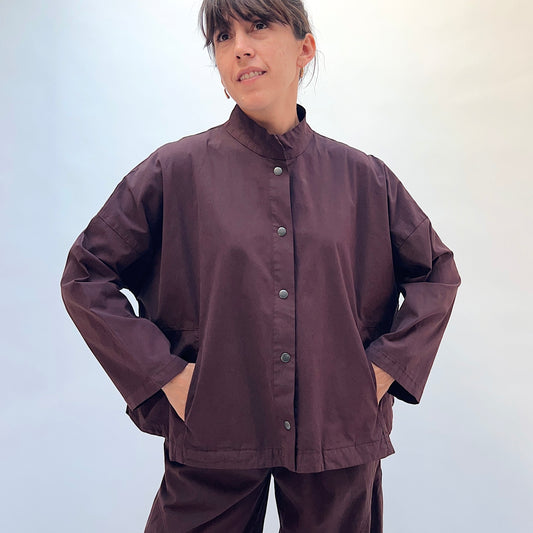 Eleven Stitch Stand Collar Jacket in Chicory, front view showing the stand collar and metal snap closure detail in deep plum cotton
