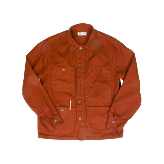 Front view of the Tellason Garment Dyed Coverall Jacket in International Orange, laid flat on a white background, showing the point collar, button front, four utility pockets, and pencil pocket detail