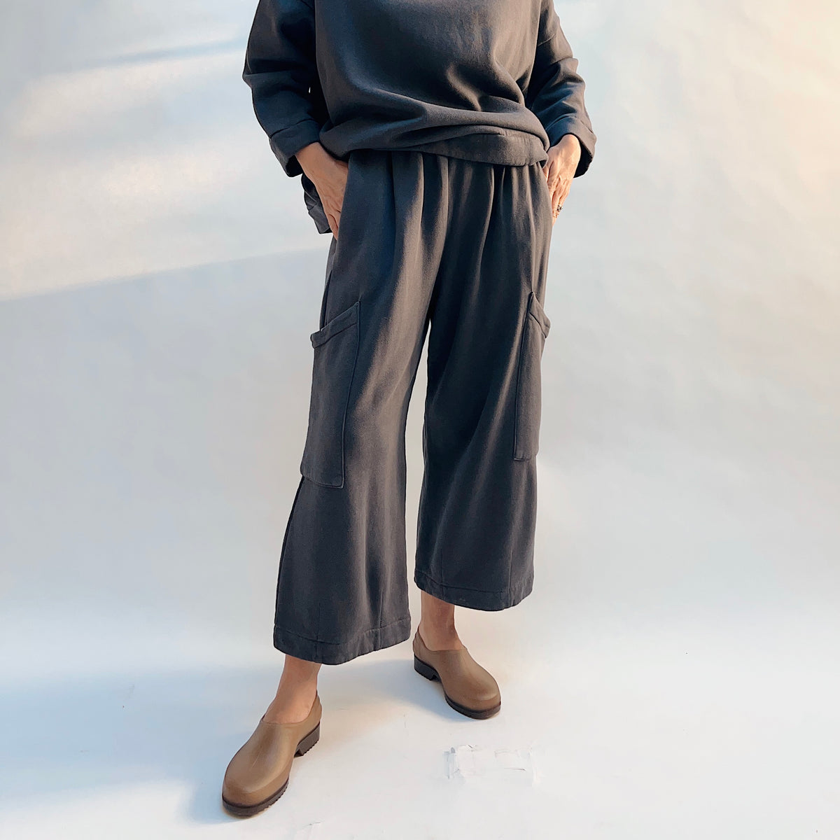 Front view of Bryn Walker Pasha Fleece Pant in Moonlight on a model, showing the cropped wide legs and large thigh patch pockets.
