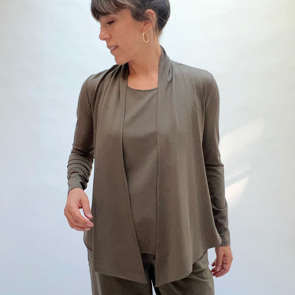 Habitat Core Travel Waterfall Jacket in Umber, front three-quarter view showing the open waterfall lapel and relaxed drape

