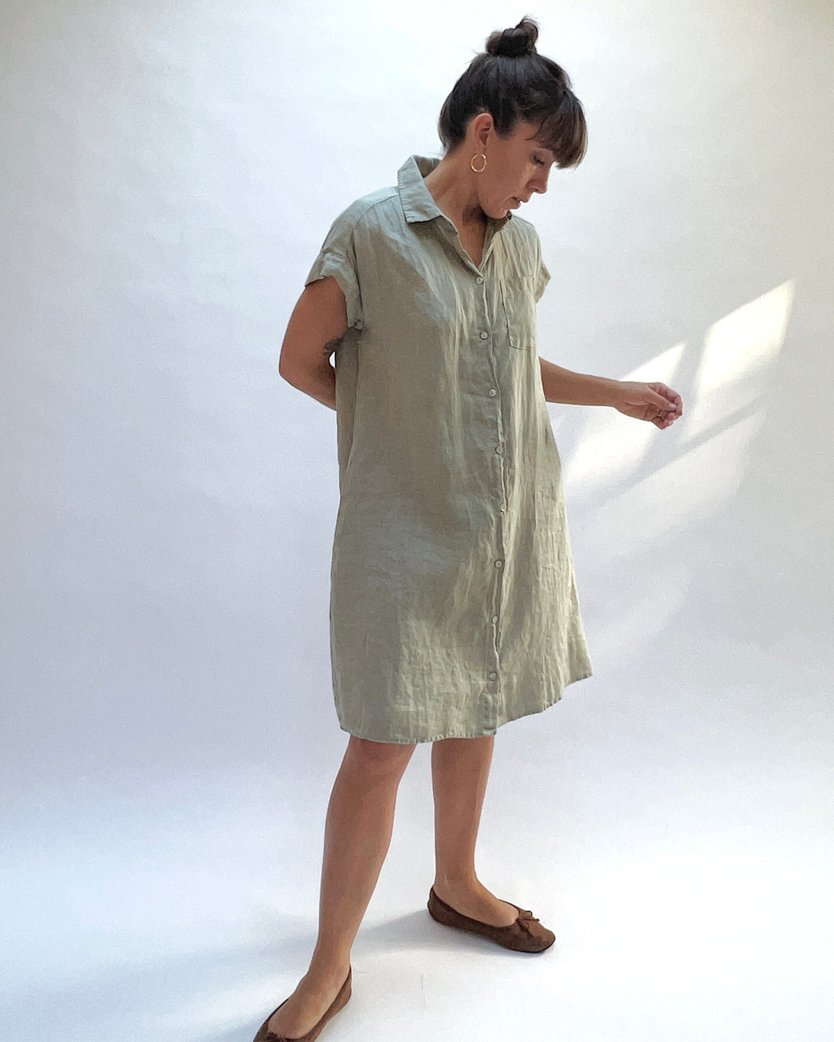 Cut Loose Hanky Linen Cap Sleeve Shirt Dress in Balsam Green, angled front view showing the collar, button front, and cap sleeves.

