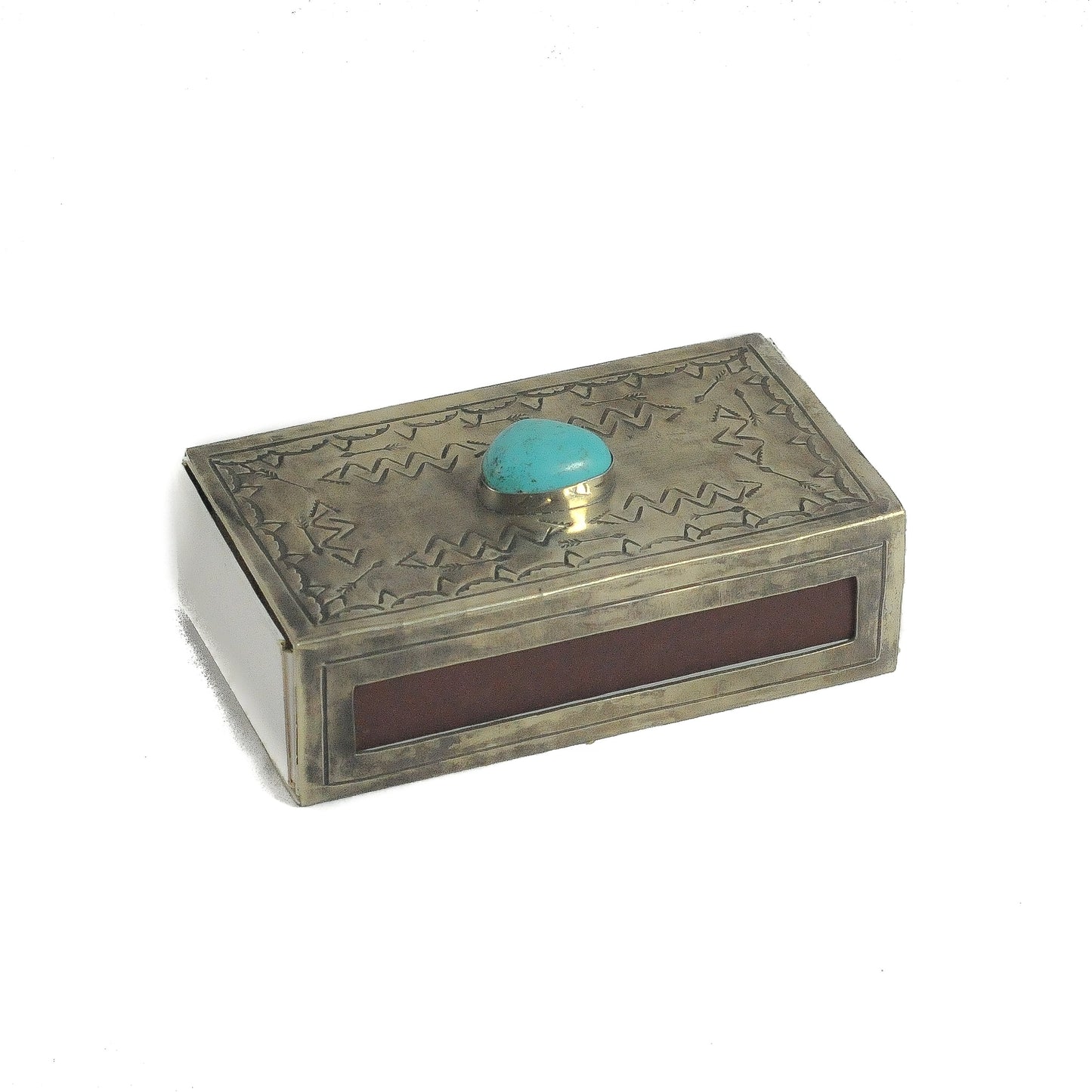Angled view of the J. Alexander Rustic Silver Large Stamped Matchbox with Turquoise, closed, showing the stamped silver lid with turquoise stone, the brown striker strip on the front face, and the aged silver finish on the sides