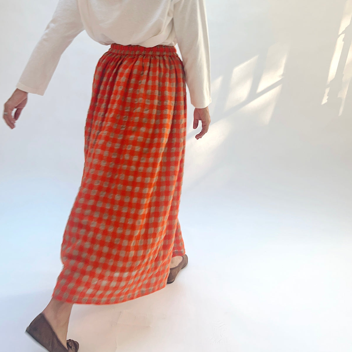 Ichi Antiquités Gingham Wool Check Skirt in Beige & Orange, side view showing the checked fabric in motion.
