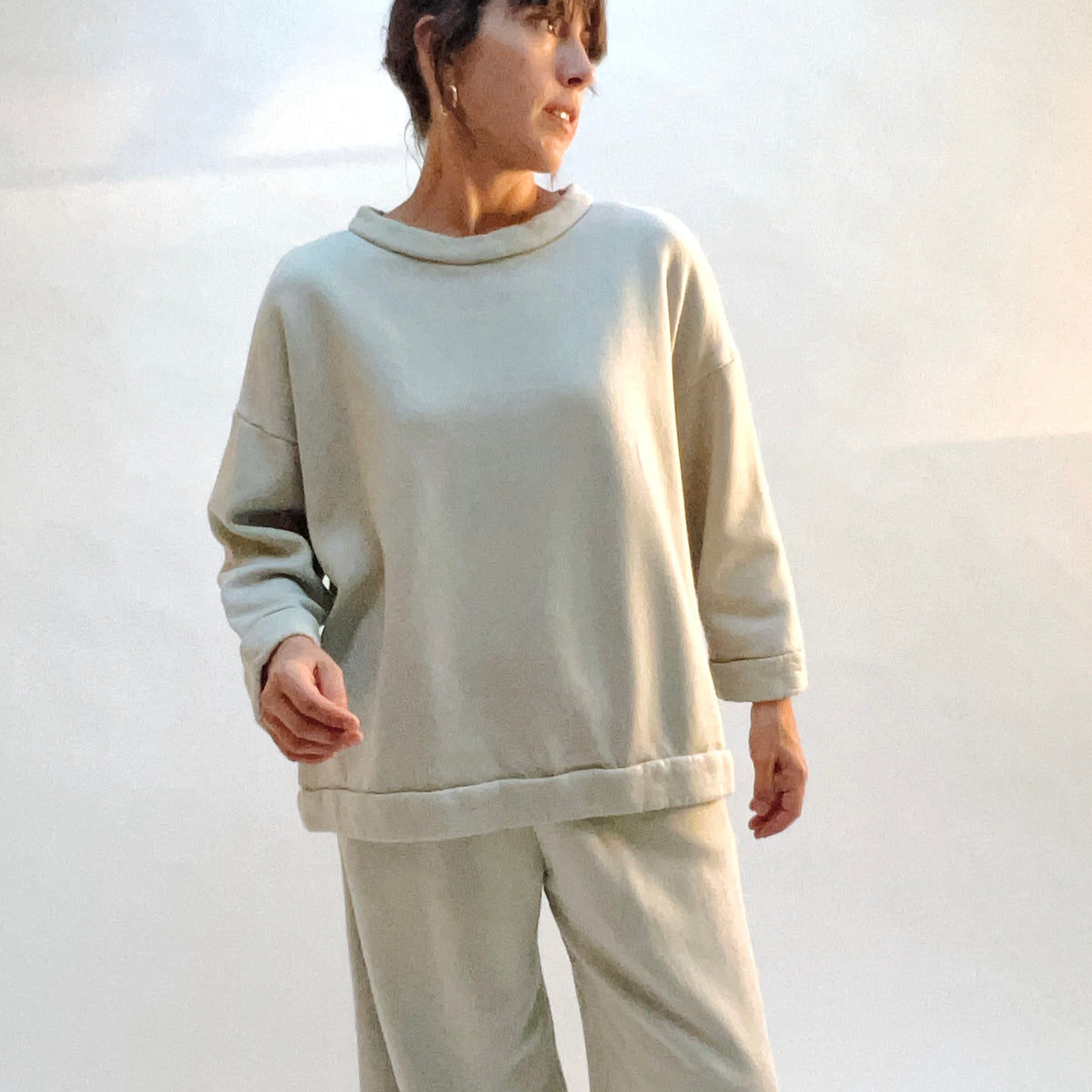 Angled front view of Alden Fleece Sweatshirt in Orlaya, showing the oversized shape and wide sleeves.
