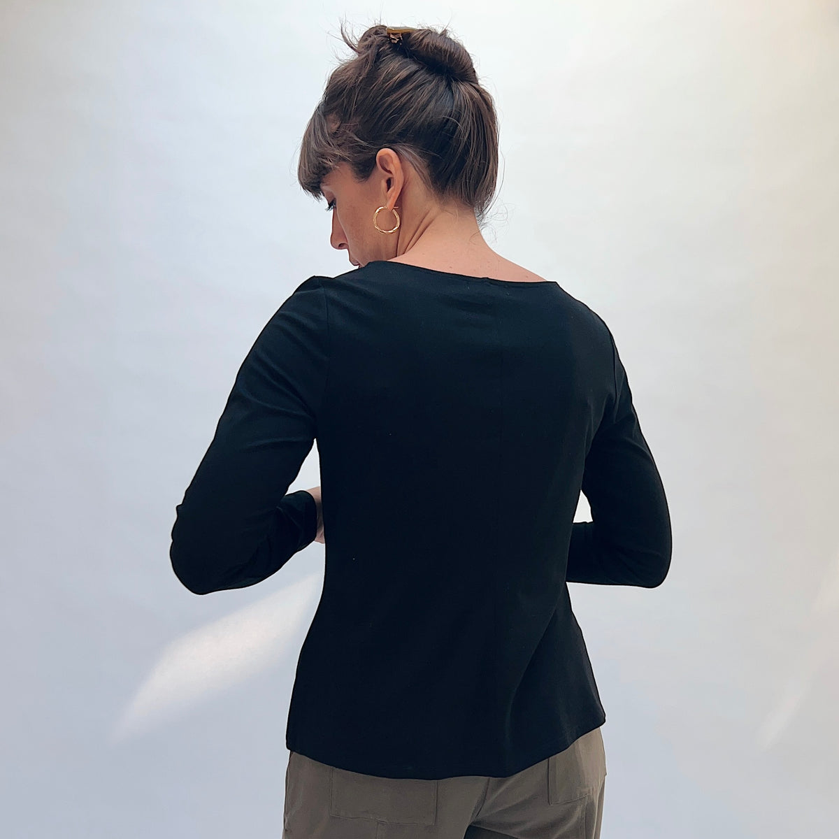 Habitat Core Travel Tie Front Top in Black, back view showing the fitted silhouette and bateau neckline
