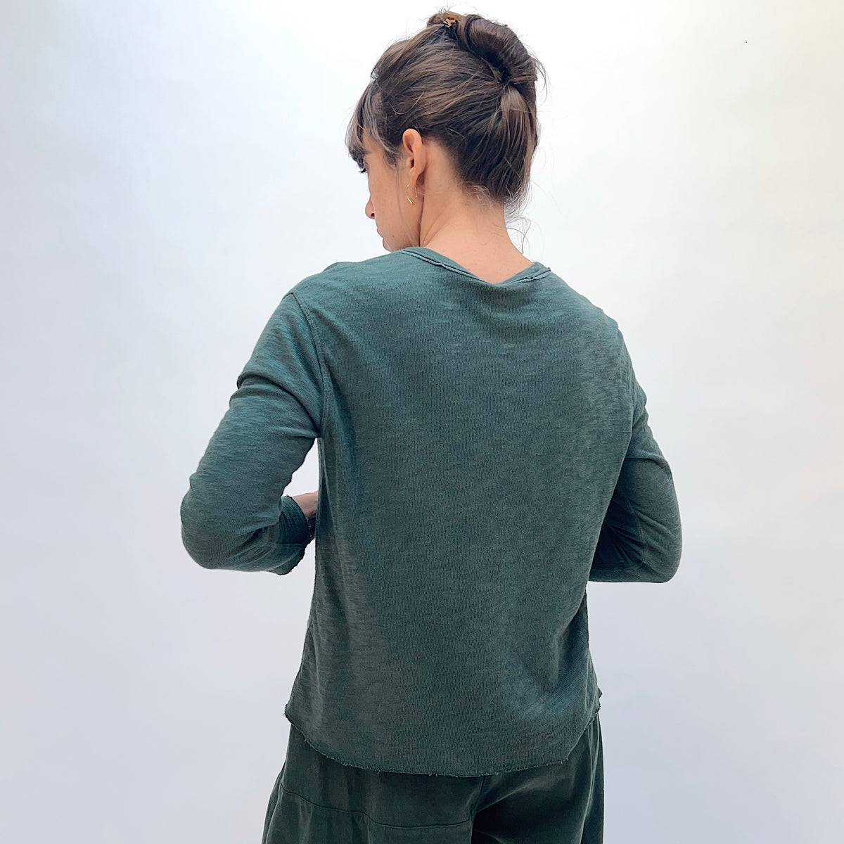 North Star Base Double Cotton Tee in Konbu, back view showing the raw-edge neckline and straight hem in konbu green
