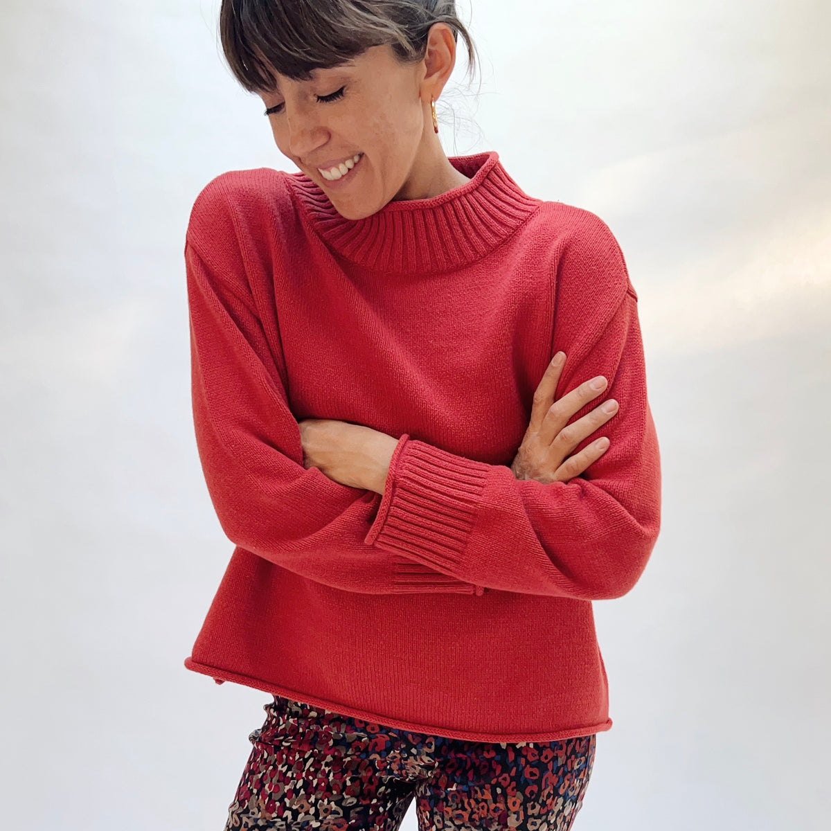 Habitat Fireside Cabin Sweater in Sienna, front three-quarter view showing the relaxed boxy fit and rolled hem in sienna red
