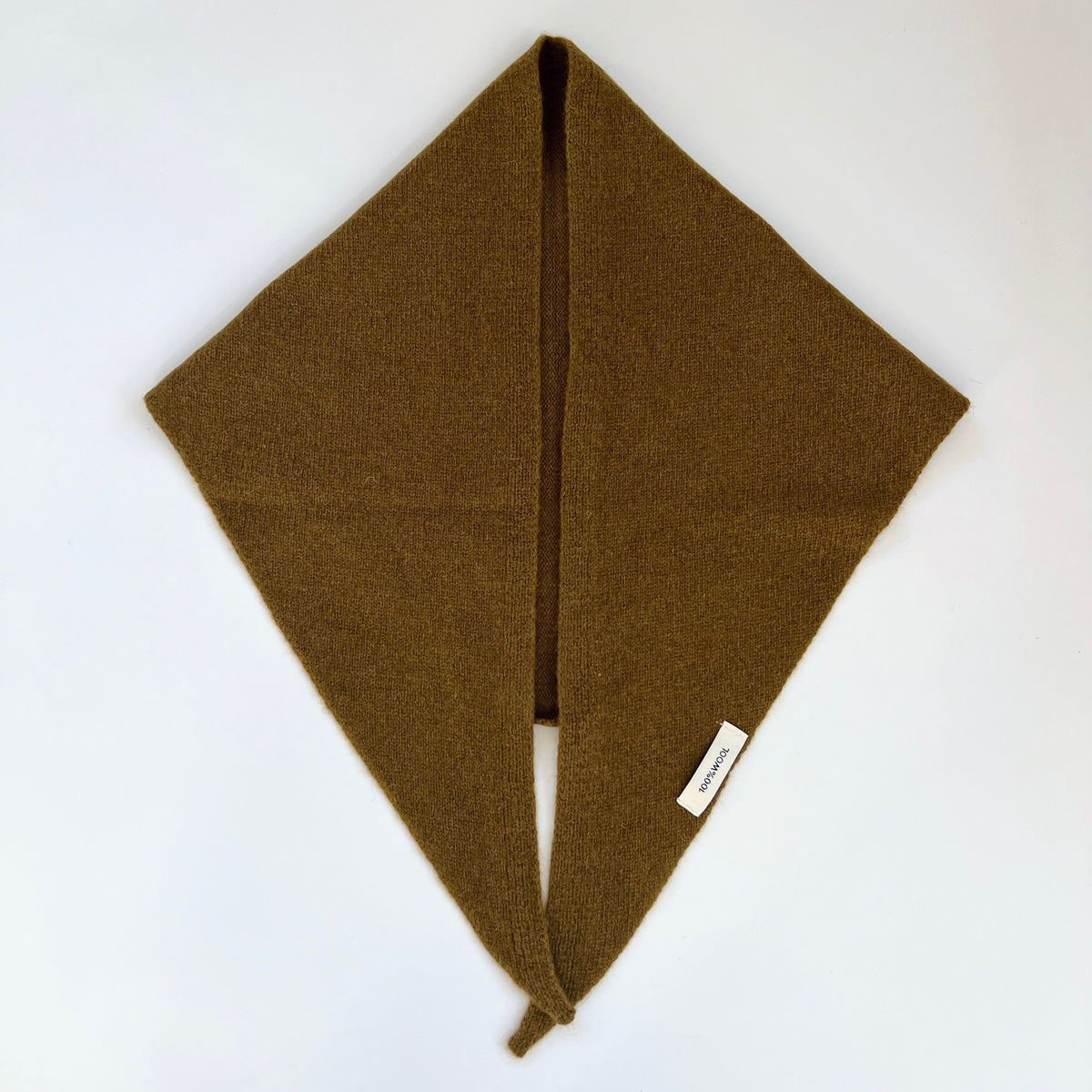 Flat lay view of the Winter Olive merino wool triangle scarf with its long ends meeting in a small knot.
