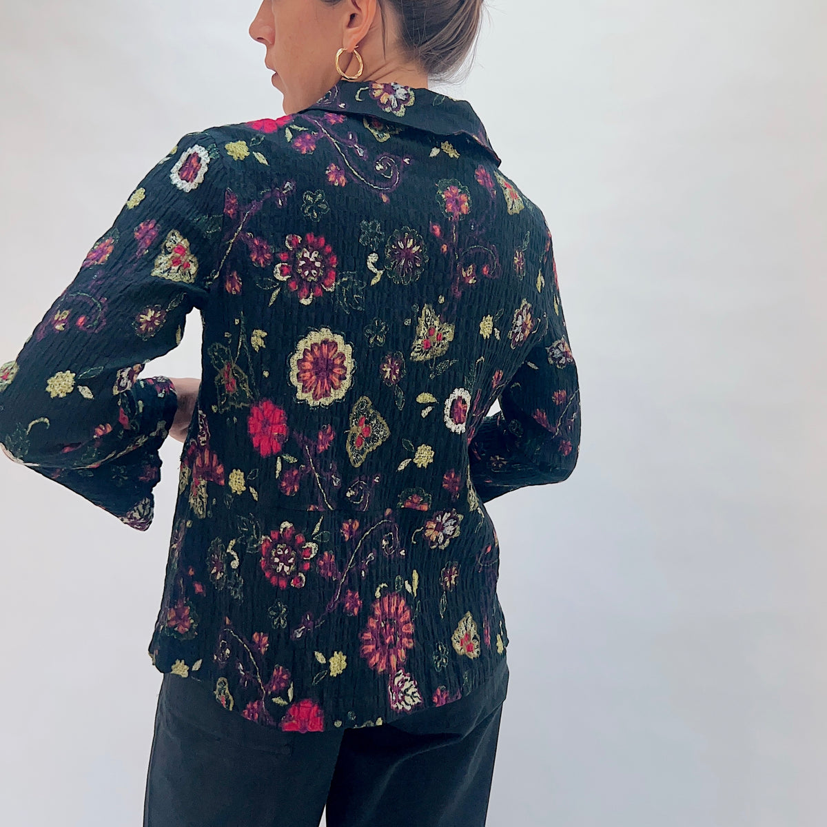 Habitat Floral Crinkle Cotton Flounce Shirt in Black, back view showing the flounced hem and multicolor floral and paisley print
