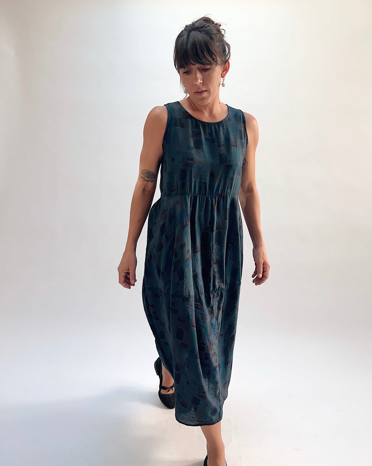 Model walking in the Cut Loose Sea Glass Seamed Parachute Bubble Dress in Etan — deep teal semi-sheer viscose-nylon with abstract brushstroke block print and gathered bubble skirt, front view
