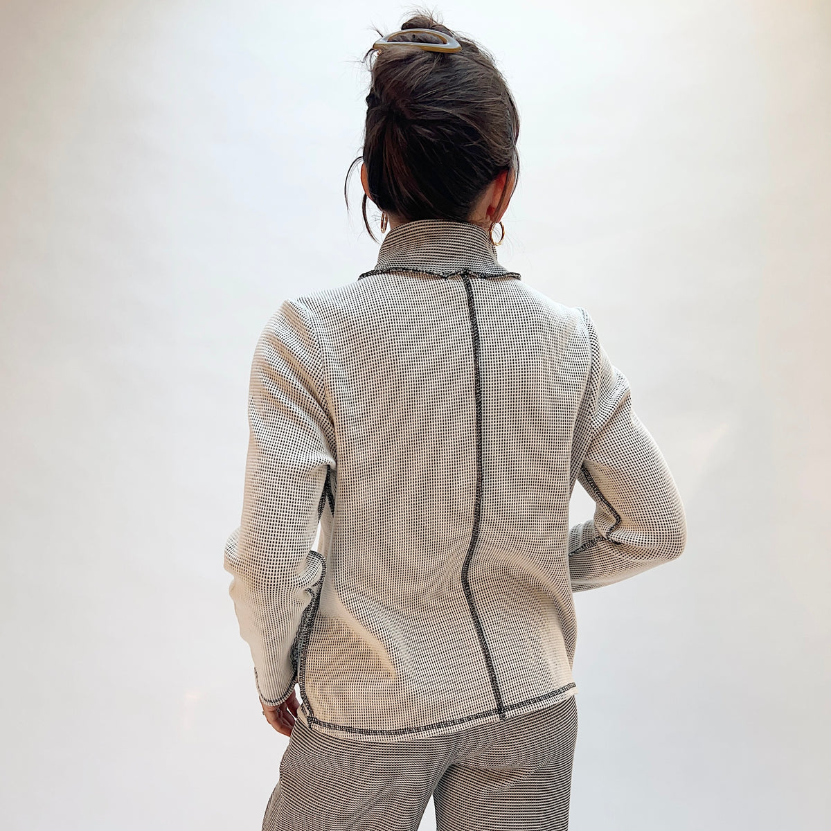 Habitat Opposites Attract Jacket in Winter White, back view showing the center back seam and contrast trim in grid-textured thermal knit
