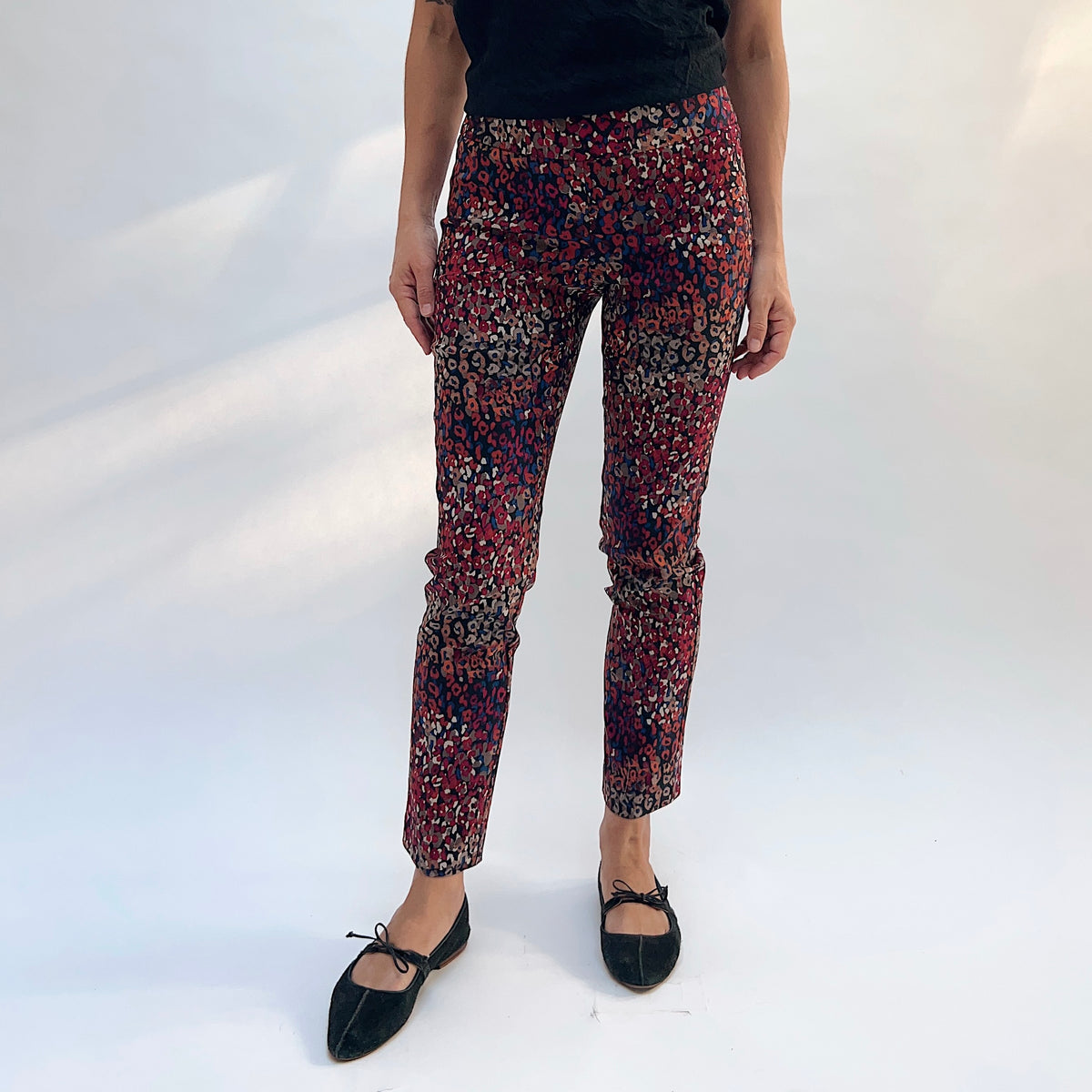 Lisette Mixed Leopard Slim Ankle Pant, front view showing the pull-on waistband and slim ankle fit in vibrant multicolor leopard print
