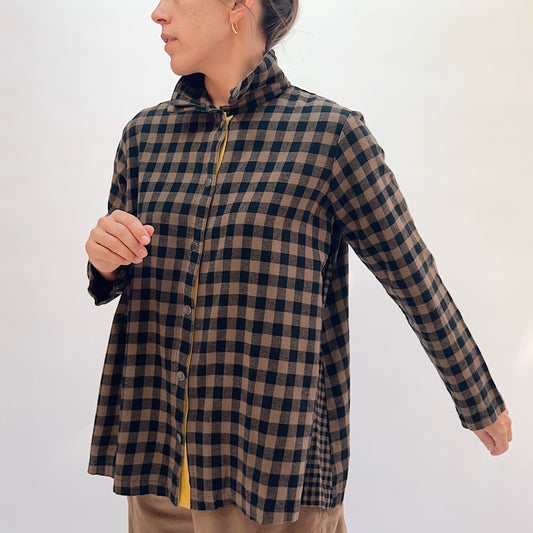 Eleven Stitch Placket Gusset Shirt in Winter Olive, three-quarter front view showing the brown and black gingham check, high funnel collar, button-front placket with yellow contrast detail, and side gusset snap vent
