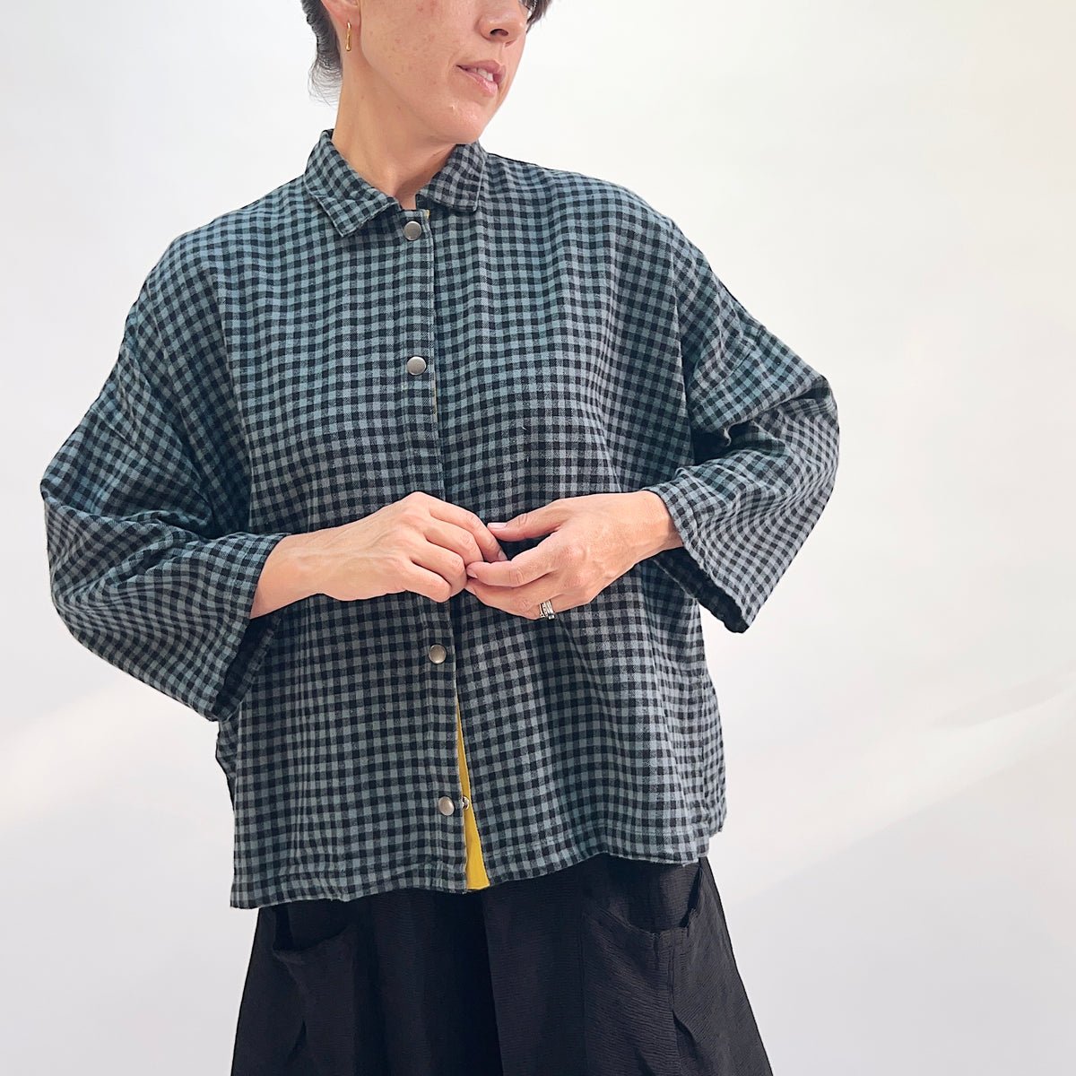 Eleven Stitch Small Check Big Shirt in Dusty Denim, front view showing the boxy oversized silhouette in dusty teal and black small gingham check flannel with point collar and mustard contrast placket
