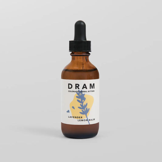 DRAM Colorado Herbal Bitters Lavender Lemon Balm Bitters 2 oz amber glass dropper bottle with illustrated label featuring a periwinkle blue lavender sprig on a soft yellow wash, against a light grey background