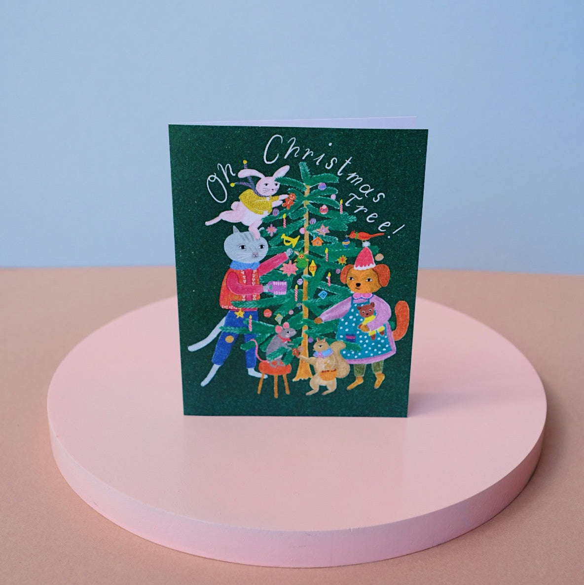 Small Adventure Christmas Tree Card, illustrated animals decorating a Christmas tree beneath the words “Oh Christmas Tree!” on a dark green background.
