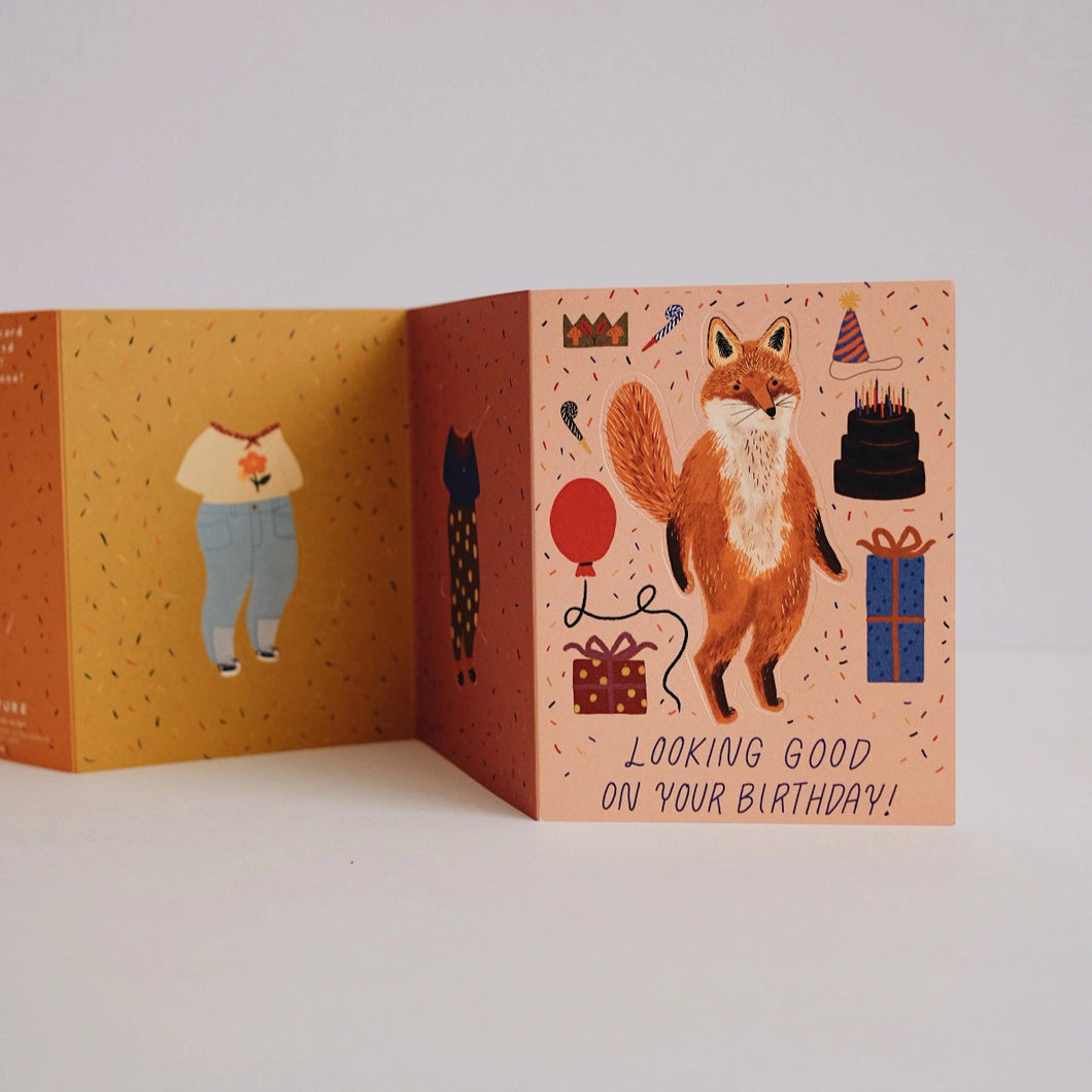 Open birthday card with fox illustration and text on a white background