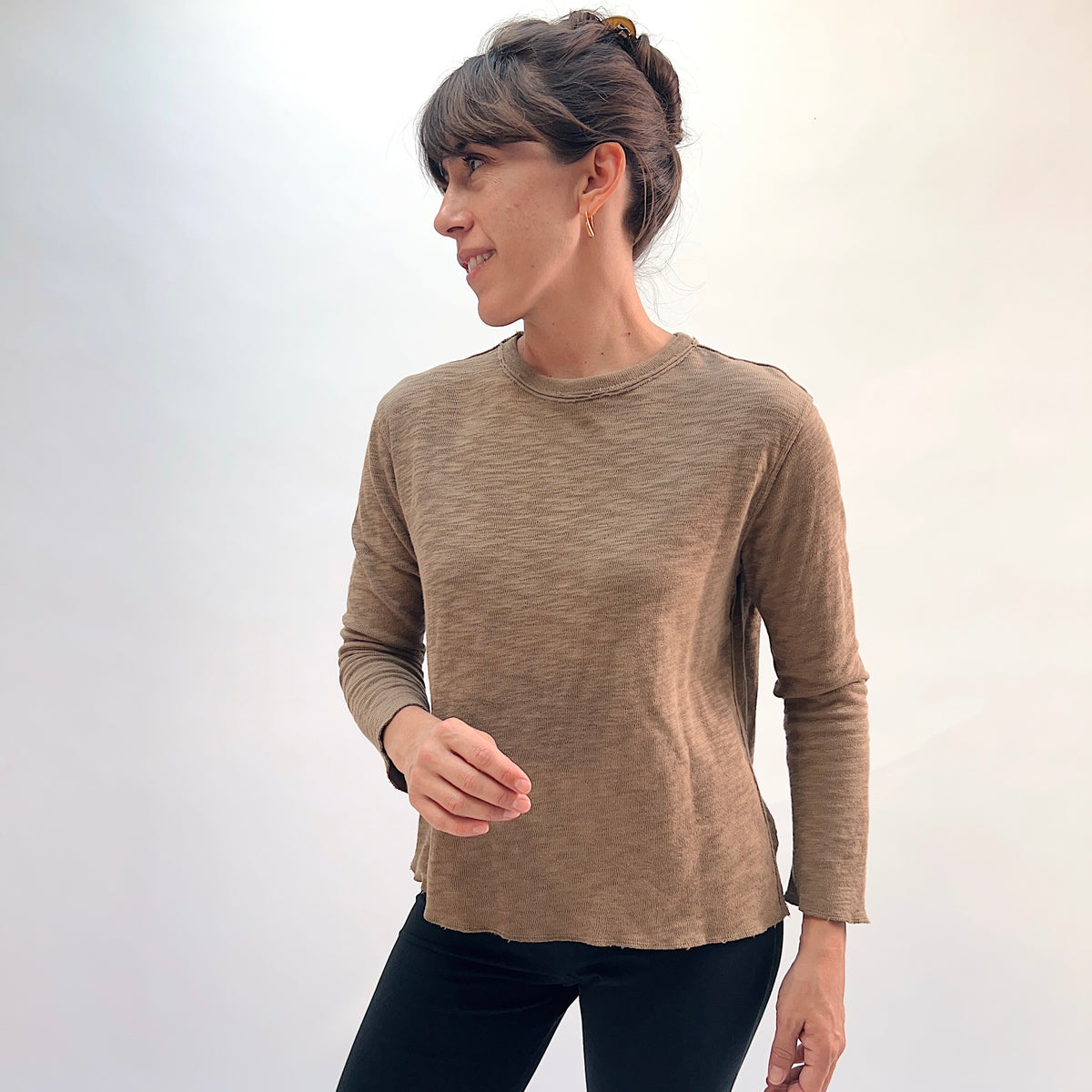 North Star Base Double Cotton Tee in Winter Olive, three-quarter view showing the crew neck with raw-edge finish and long sleeves in warm olive
