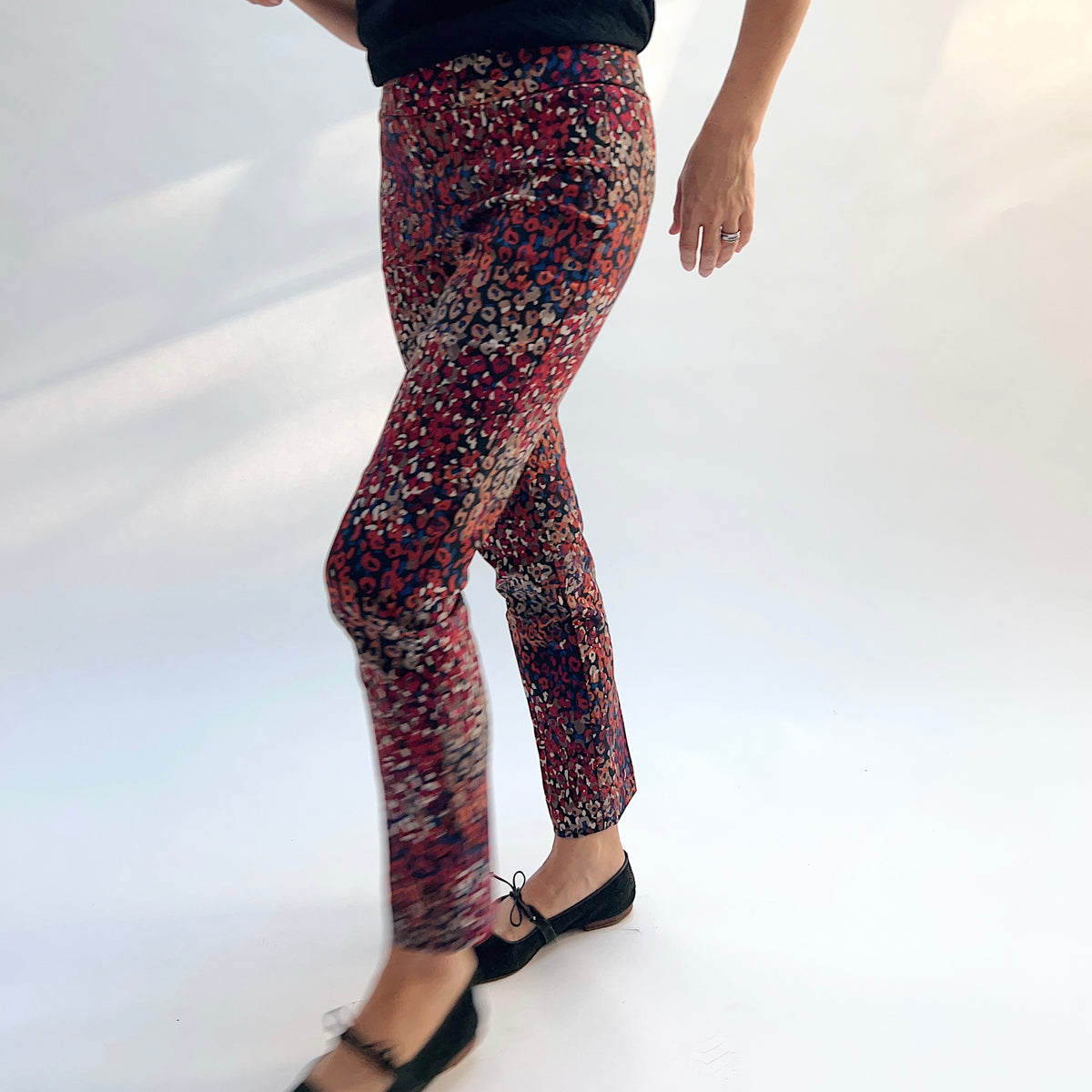 Lisette Mixed Leopard Slim Ankle Pant, side view in motion showing the slim ankle fit and vibrant mixed leopard print

