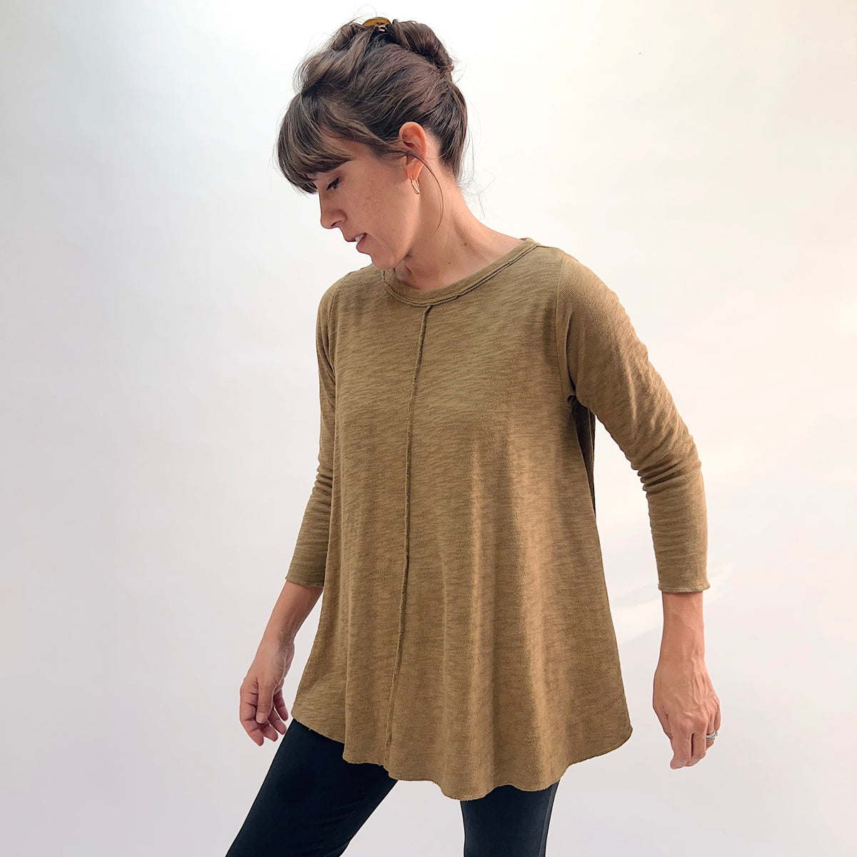North Star Base Shorter High Low Double Cotton Tee in Olive, front view showing the full A-line swing silhouette and center front seam detail in olive

