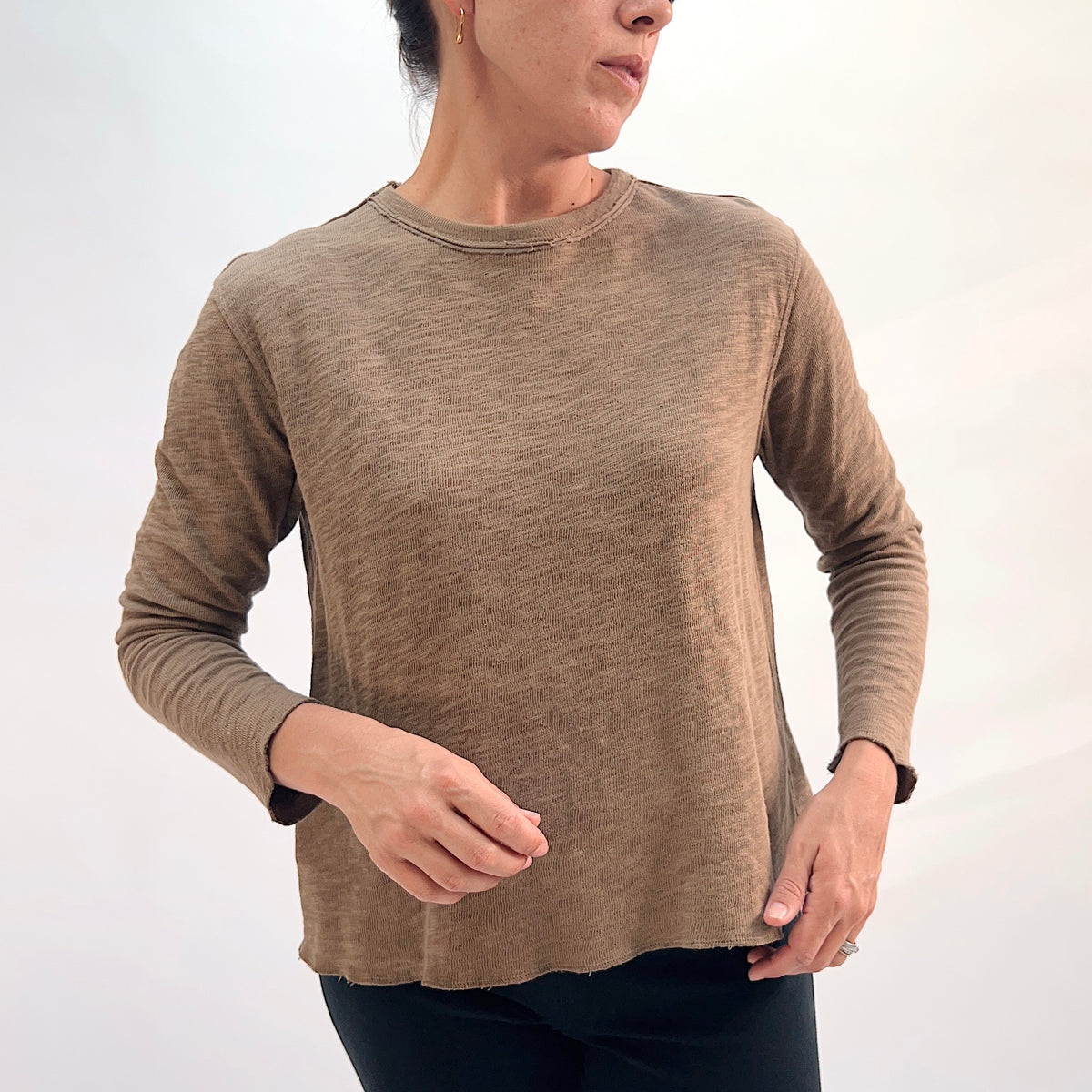 North Star Base Double Cotton Tee in Winter Olive, front view showing the raw-edge neckline finish and relaxed fit in warm olive
